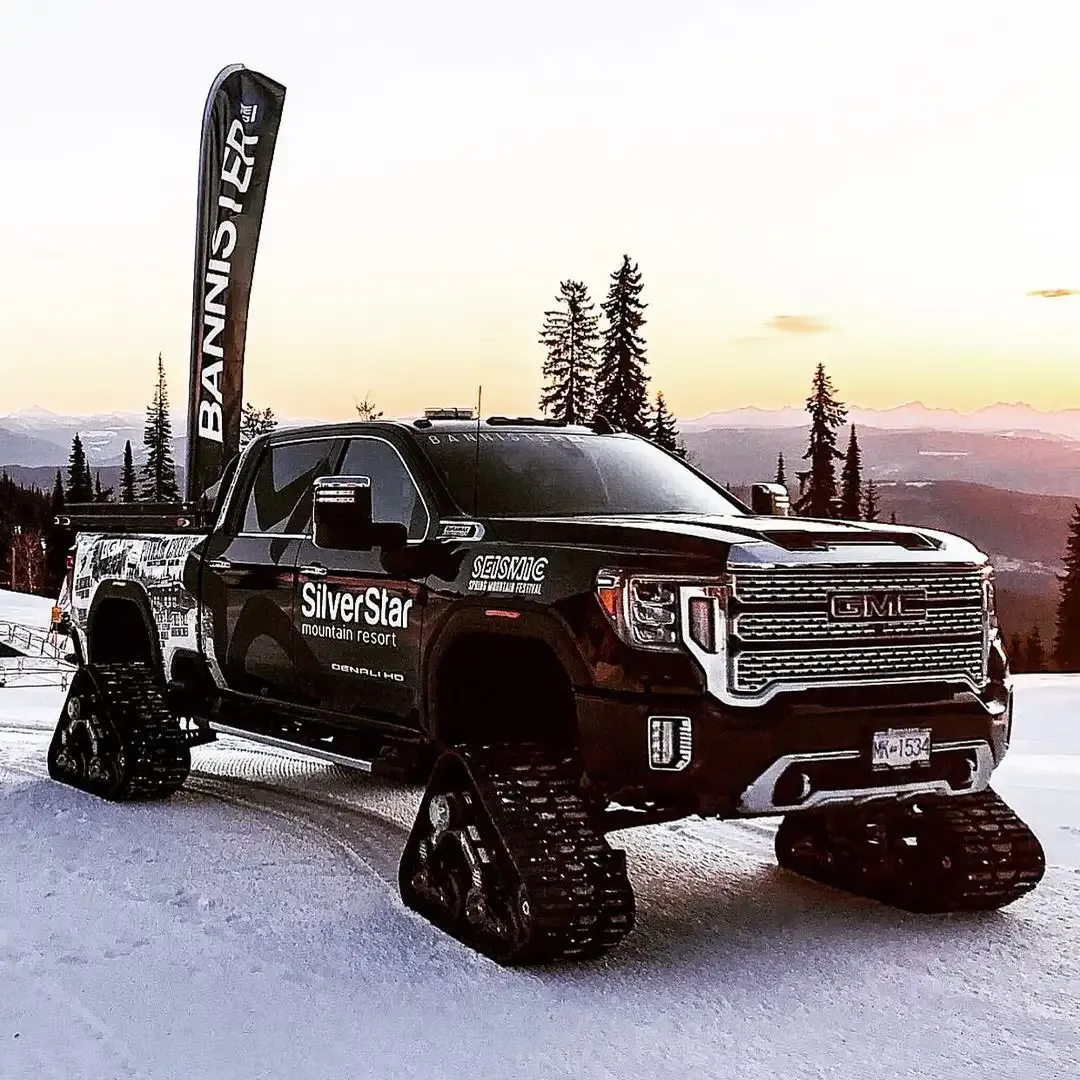 Bannister GM truck wrapped for SilverStar Mountain Resort, on snow tracks at sunset